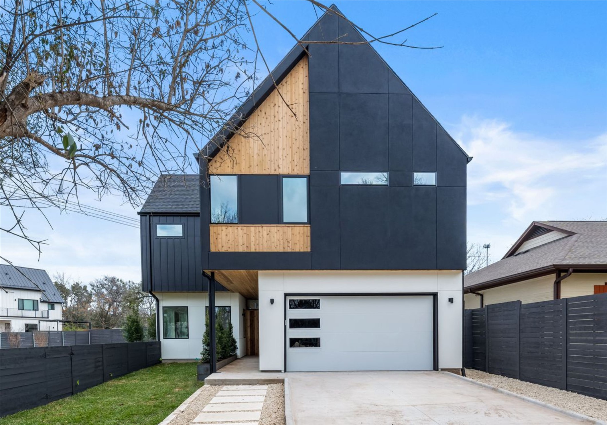 1703 Miami Drive Austin, TX 78733 - Photo 2 of 35 Modern design with earthy wood accent siding