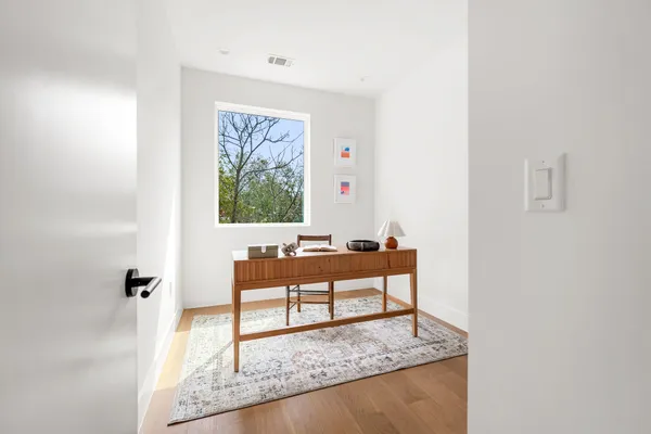 a living room with furniture and a rug