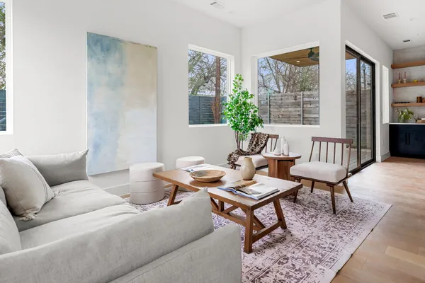 a living room with furniture and a potted plant
