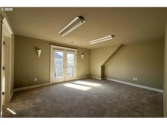 a view of an empty room with windows