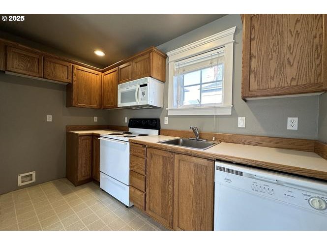 1505 Northeast Village Street Fairview, OR 97024 - Photo 27 of 33 a kitchen with a sink stove and cabinets