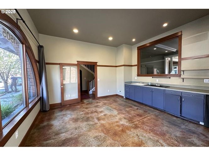 1505 Northeast Village Street Fairview, OR 97024 - Photo 3 of 33 a living room with stainless steel appliances kitchen island granite countertop a refrigerator a sink and a large window