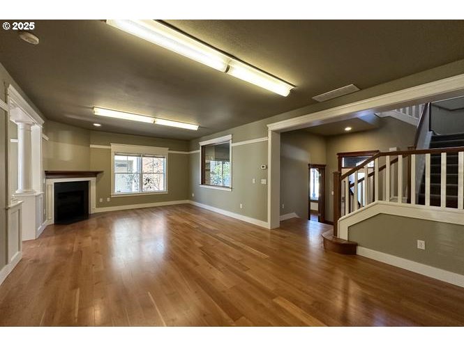 1505 Northeast Village Street Fairview, OR 97024 - Photo 5 of 33 a view of an empty room with wooden floor and a window