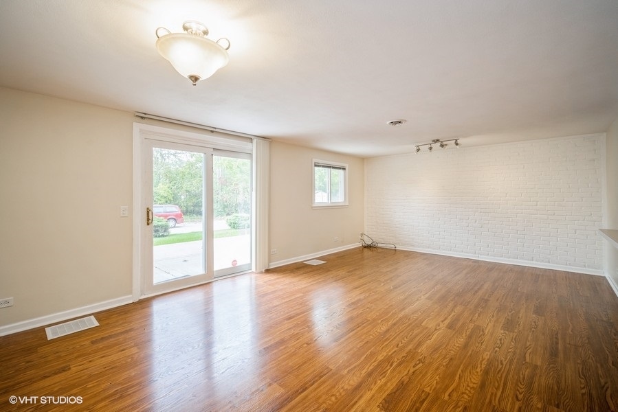 912 Chestnut Street Deerfield, IL 60015 - Photo 13 of 20 an empty room with wooden floor and windows