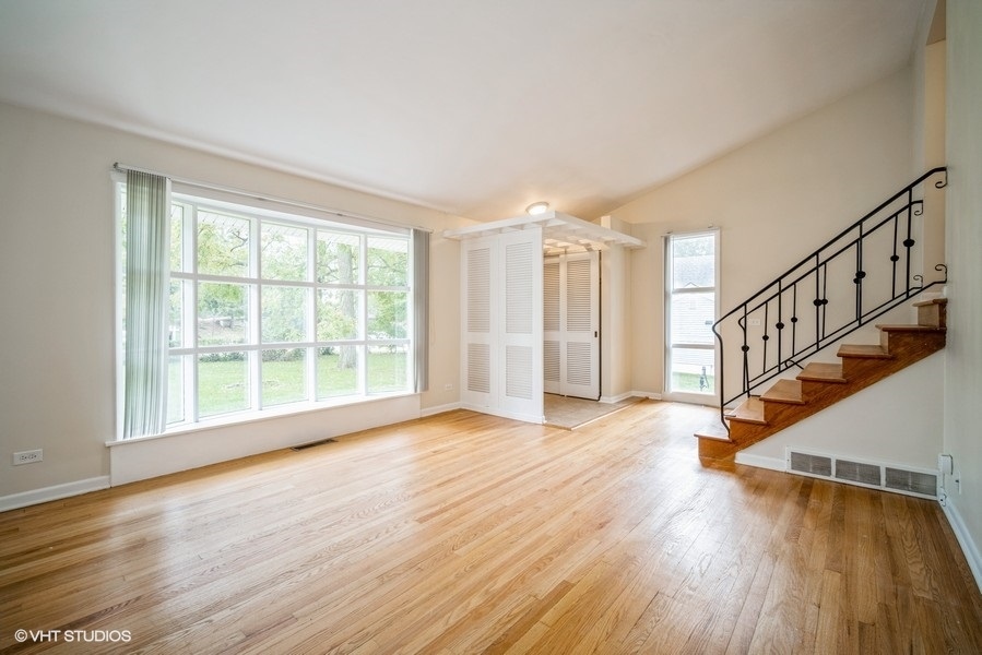 912 Chestnut Street Deerfield, IL 60015 - Photo 3 of 20 a view of an empty room with wooden floor and a window