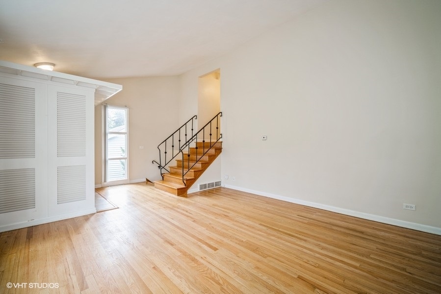 912 Chestnut Street Deerfield, IL 60015 - Photo 4 of 20 a view of an empty room with wooden floor and a window