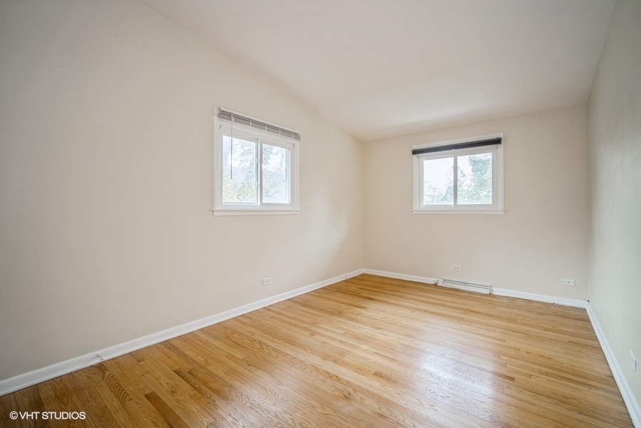 912 Chestnut Street Deerfield, IL 60015 - Photo 6 of 20 a view of an empty room with wooden floor and a window