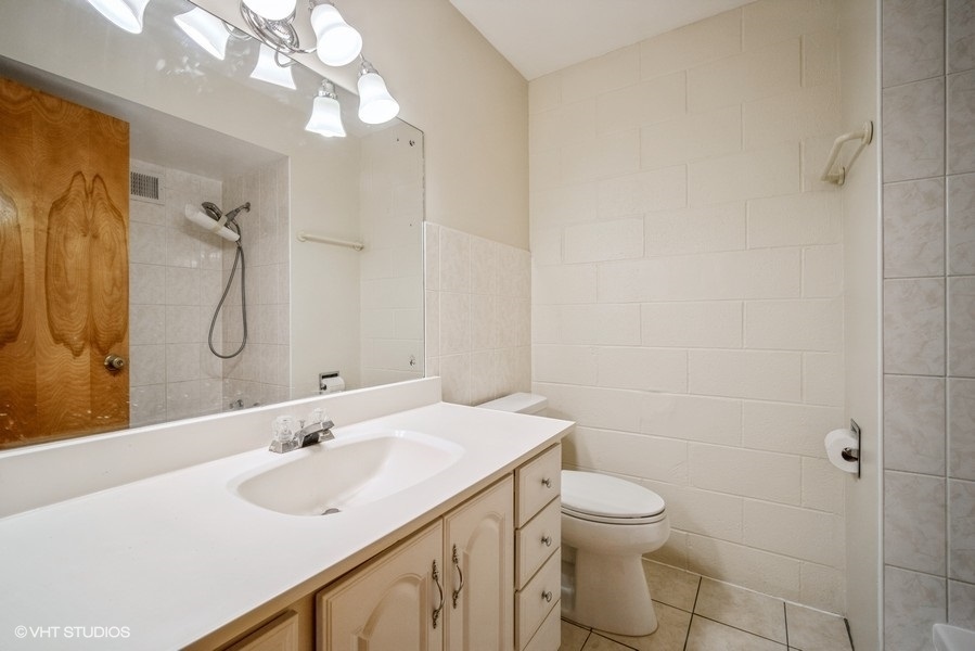 912 Chestnut Street Deerfield, IL 60015 - Photo 10 of 20 a bathroom with a sink a toilet and shower