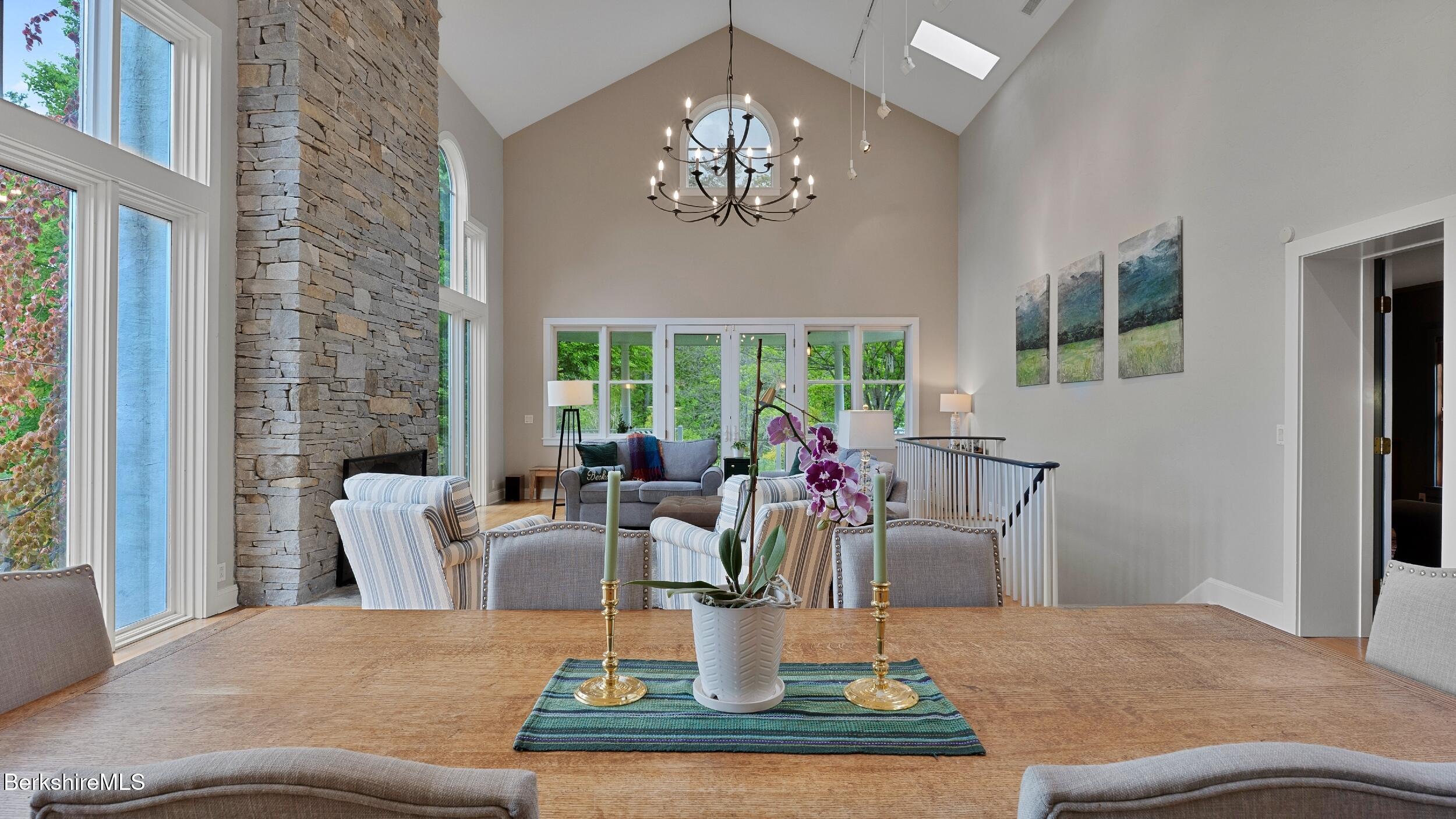 1488 State Road Richmond, MA 01254 - Photo 13 of 70 a view of a dining room with furniture a chandelier and windows