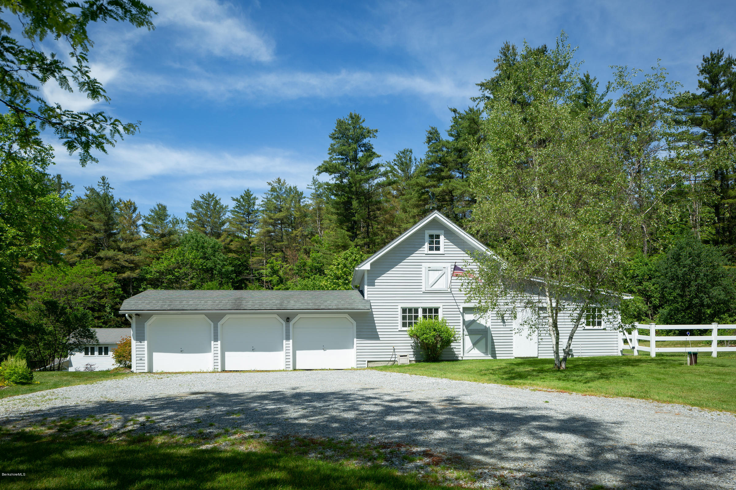 1488 State Road Richmond, MA 01254 - Photo 54 of 70 a front view of a house with a yard and garage