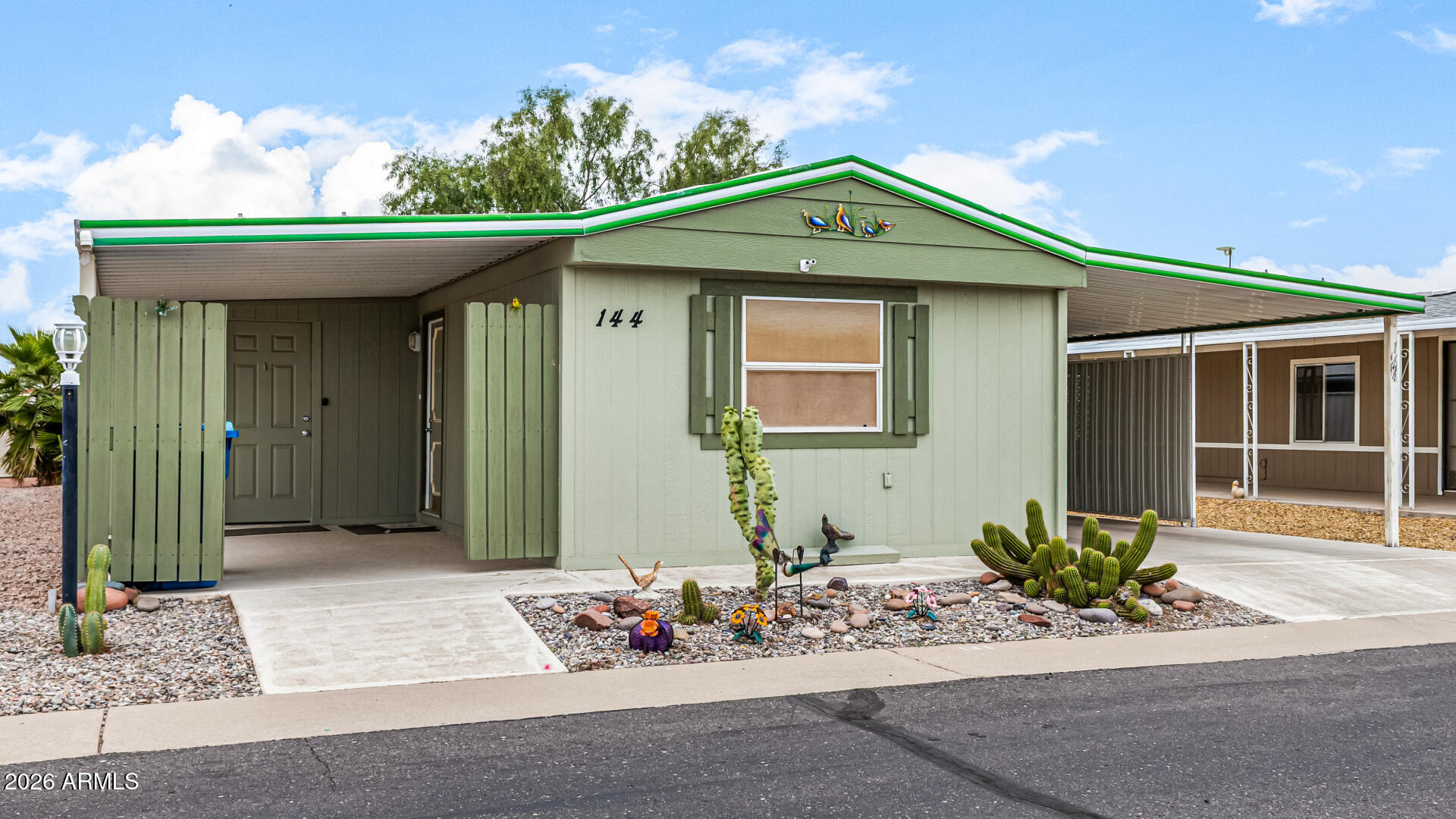 834 South Meridian Road, Unit 144 Apache Junction, AZ 85120 - Photo 6 of 43 a front view of a house with a yard