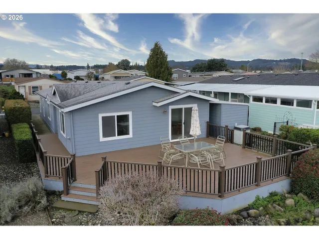 a view of a house with a wooden deck