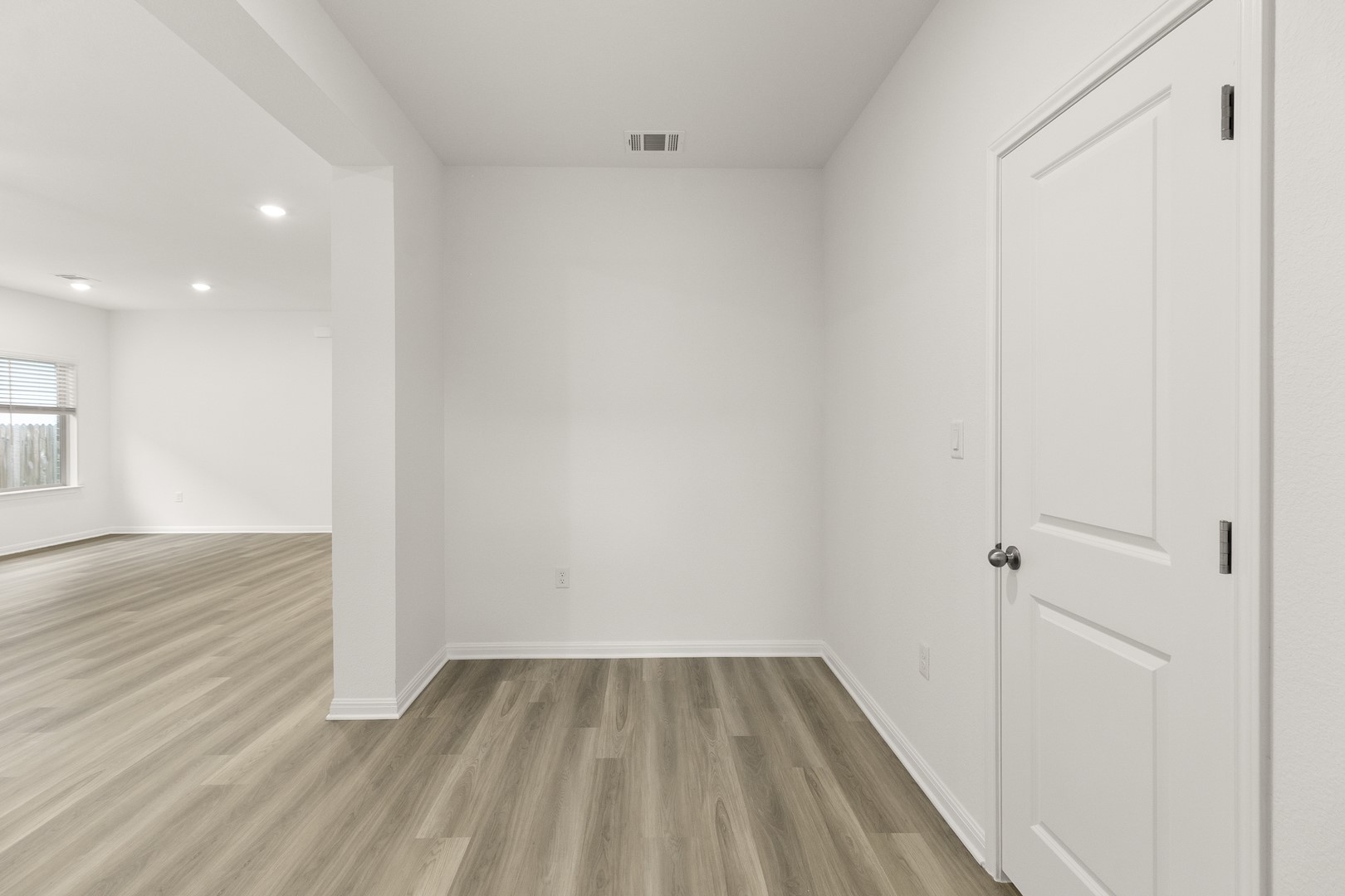 18605 Emu Lane Manor, TX 78653 - Photo 15 of 27 The property features light-toned flooring, white walls, and a white door with a round dark doorknob