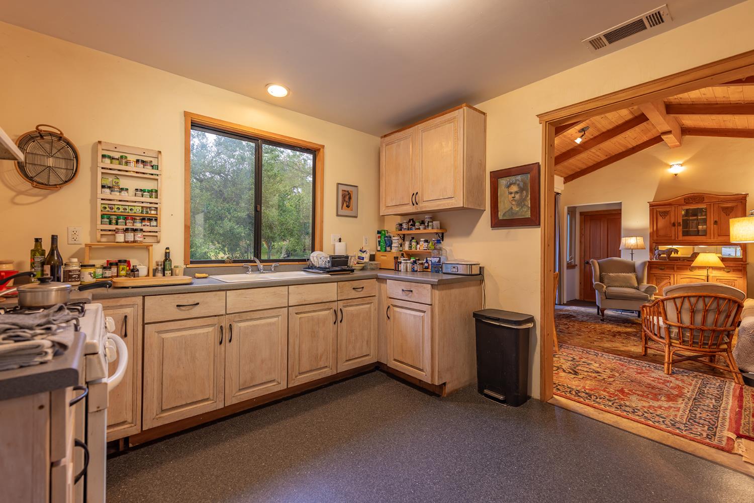 11954 Sulphur Mountain Road Ojai, CA 93023 - Photo 23 of 41 a open kitchen with granite countertop a sink appliances cabinets and a large window