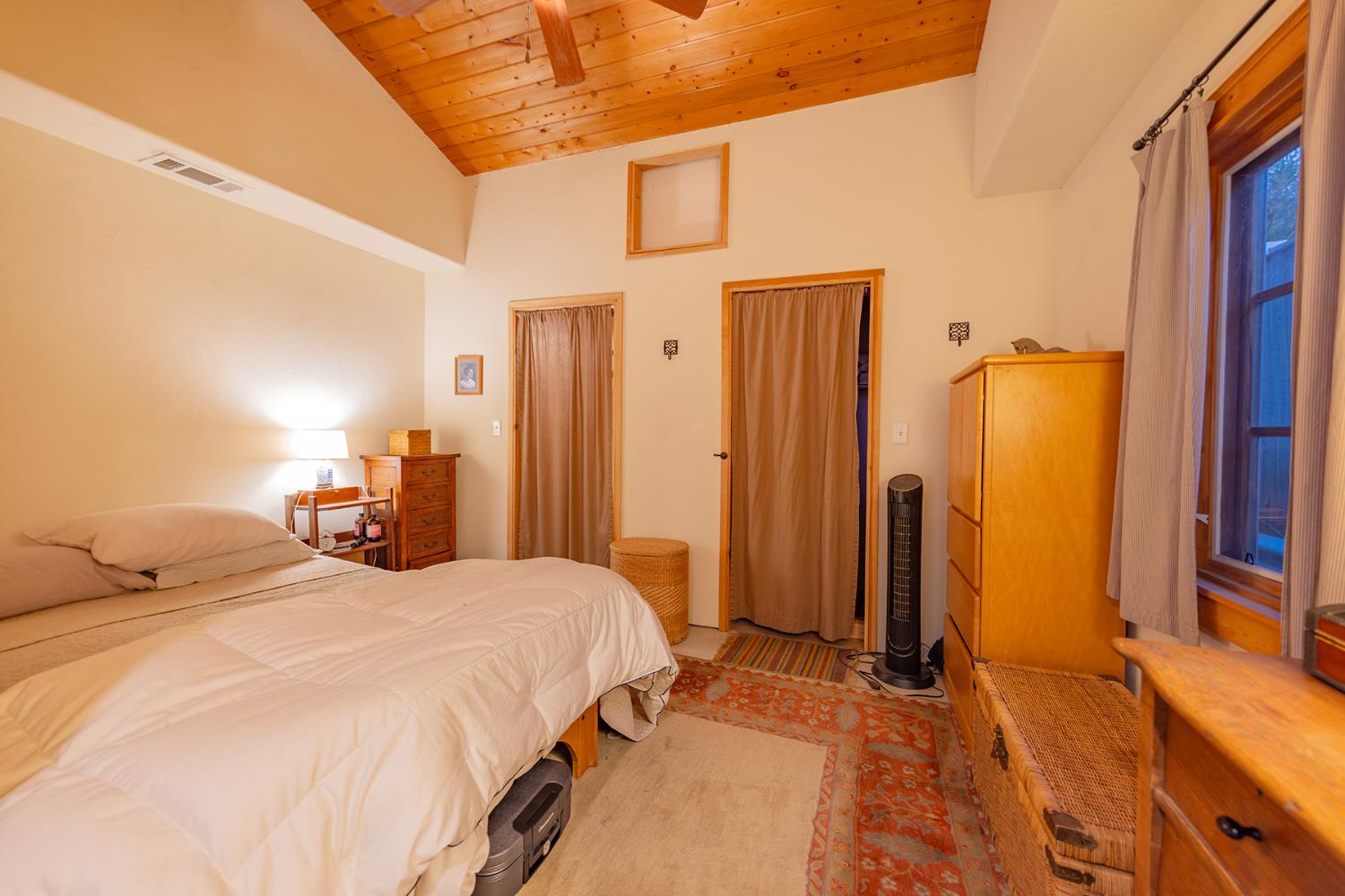 11954 Sulphur Mountain Road Ojai, CA 93023 - Photo 25 of 41 a bedroom with a bed a dresser next to a window