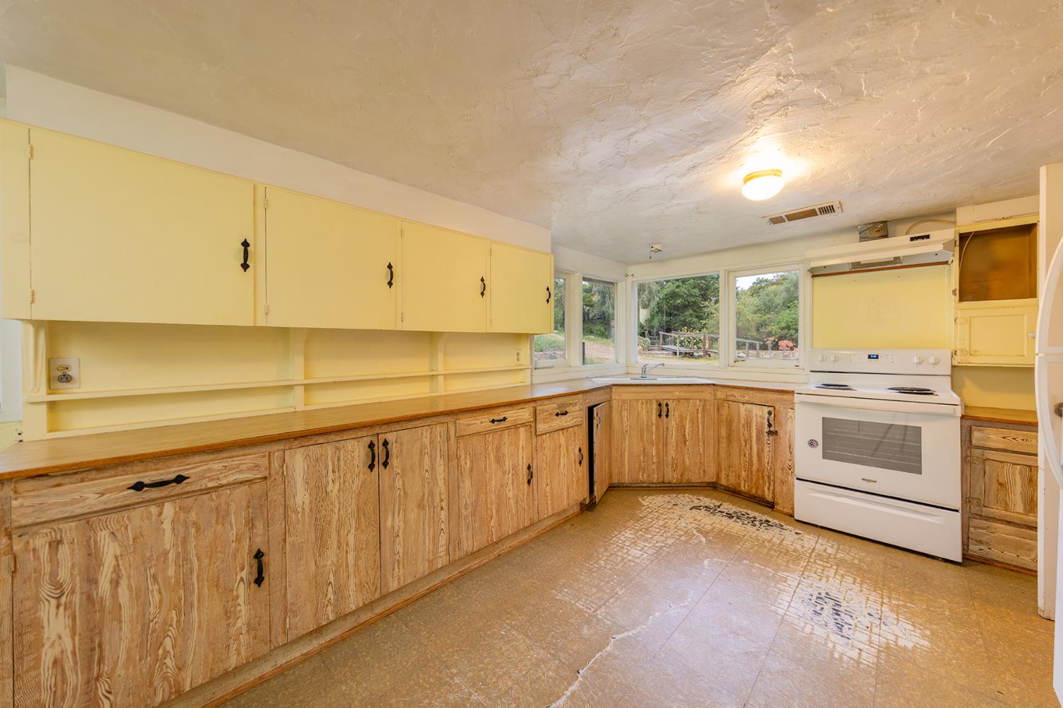 11954 Sulphur Mountain Road Ojai, CA 93023 - Photo 35 of 41 a kitchen with granite countertop white cabinets and white stainless steel appliances