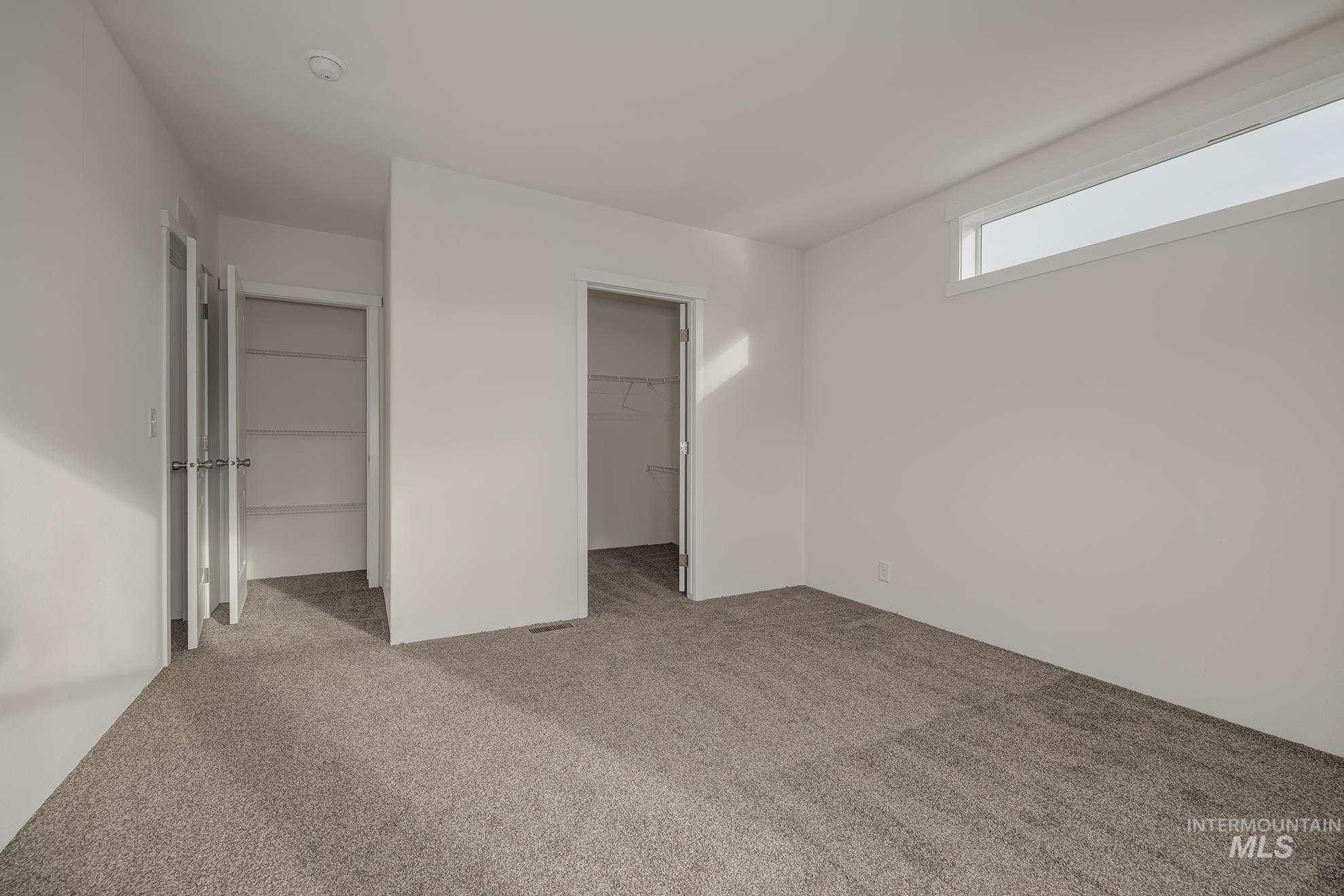 2750 Alden Road, Unit 8 Fruitland, ID 83619 - Photo 17 of 31 Unfurnished bedroom featuring light colored carpet and a spacious closet