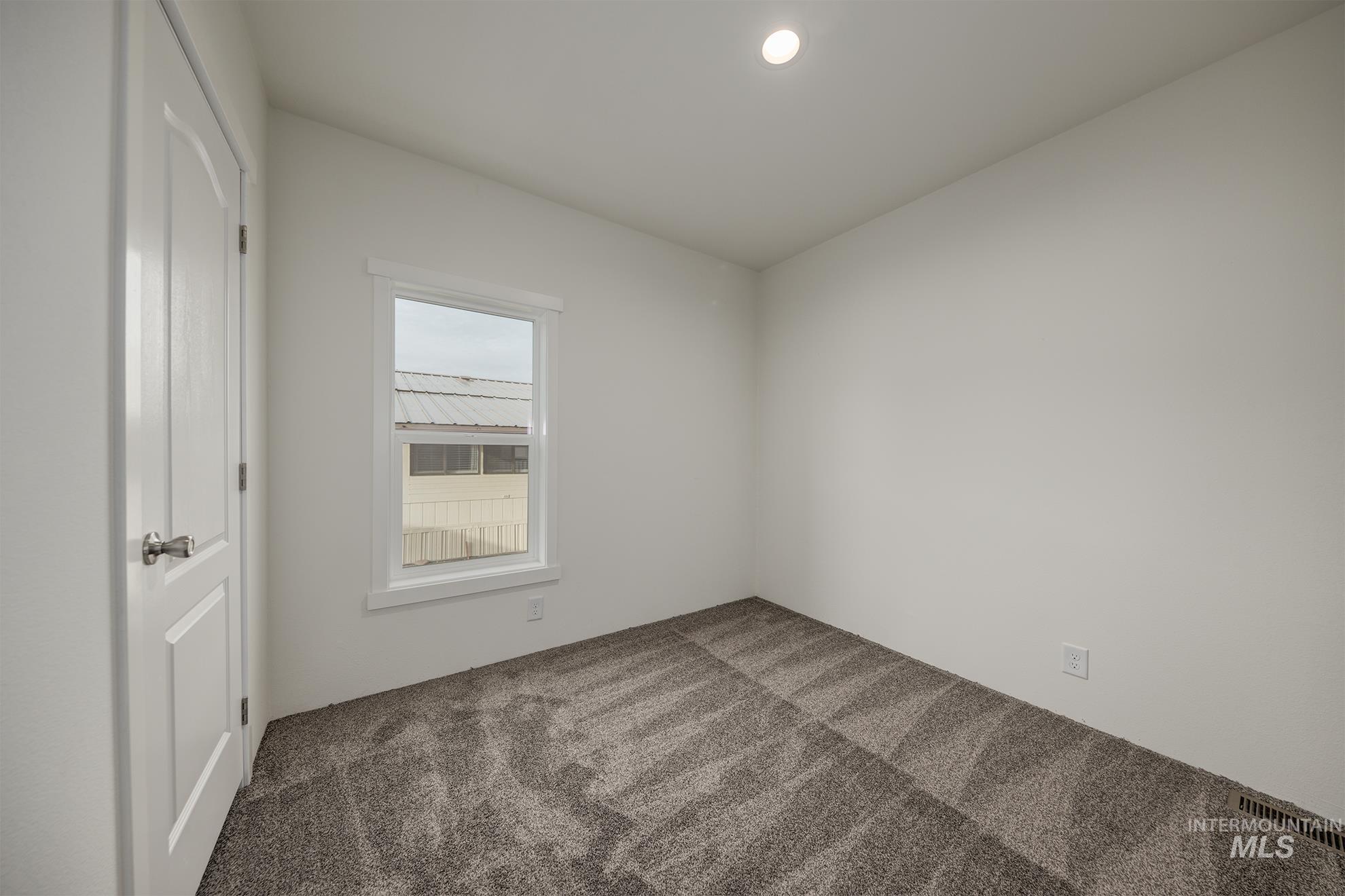 2750 Alden Road, Unit 8 Fruitland, ID 83619 - Photo 21 of 31 Unfurnished bedroom with carpet flooring, a closet, and recessed lighting