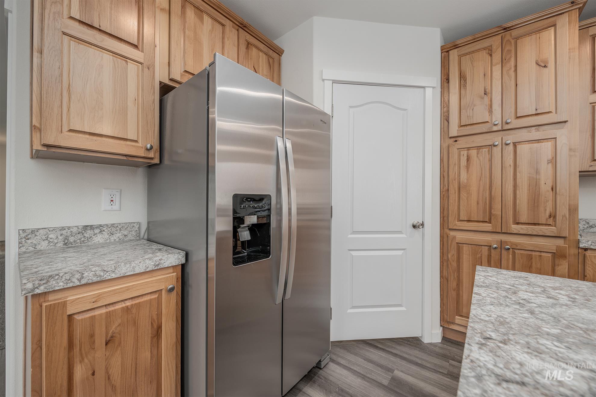 2750 Alden Road, Unit 8 Fruitland, ID 83619 - Photo 5 of 31 Kitchen featuring stainless steel fridge with ice dispenser, light countertops, and wood finished floors