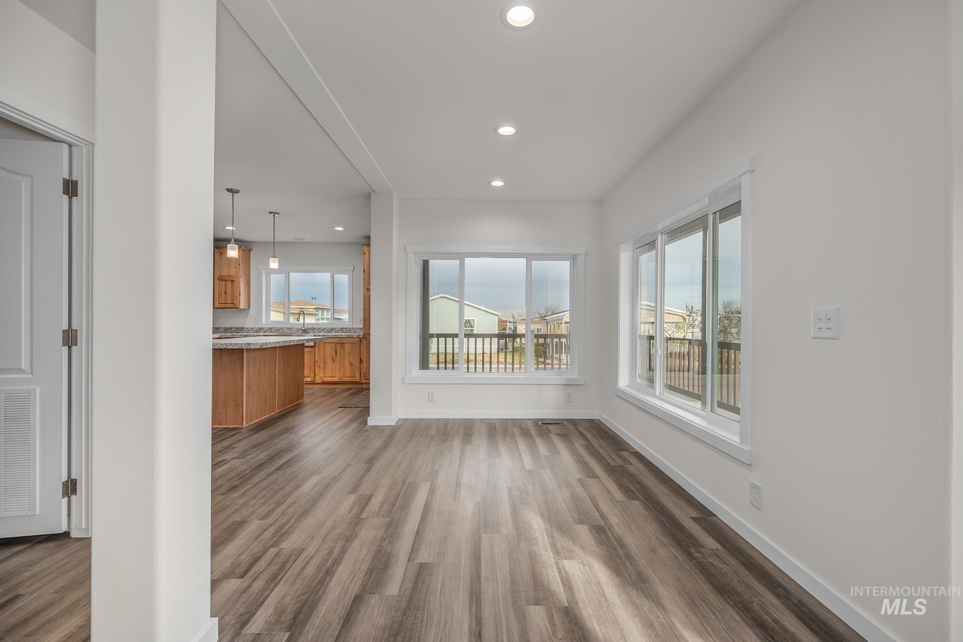 2750 Alden Road, Unit 8 Fruitland, ID 83619 - Photo 8 of 31 Unfurnished living room with recessed lighting and dark wood-style flooring