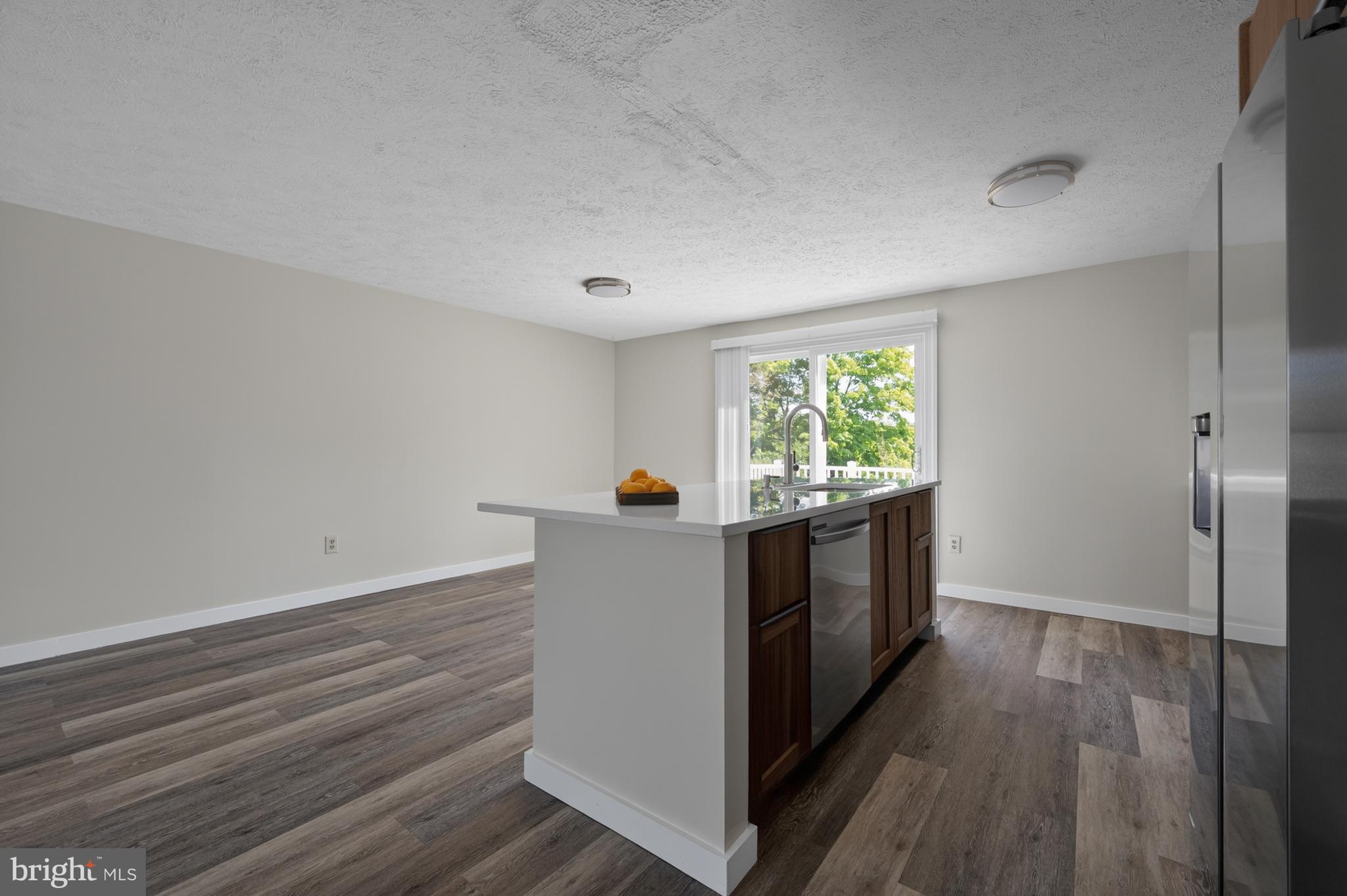4429 Cub Run Road Chantilly, VA 20151 - Photo 12 of 56 a kitchen with granite countertop white cabinets and white appliances