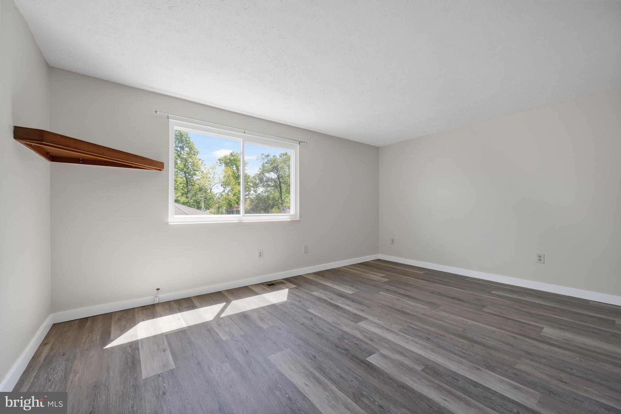 4429 Cub Run Road Chantilly, VA 20151 - Photo 18 of 56 an empty room with wooden floor and windows