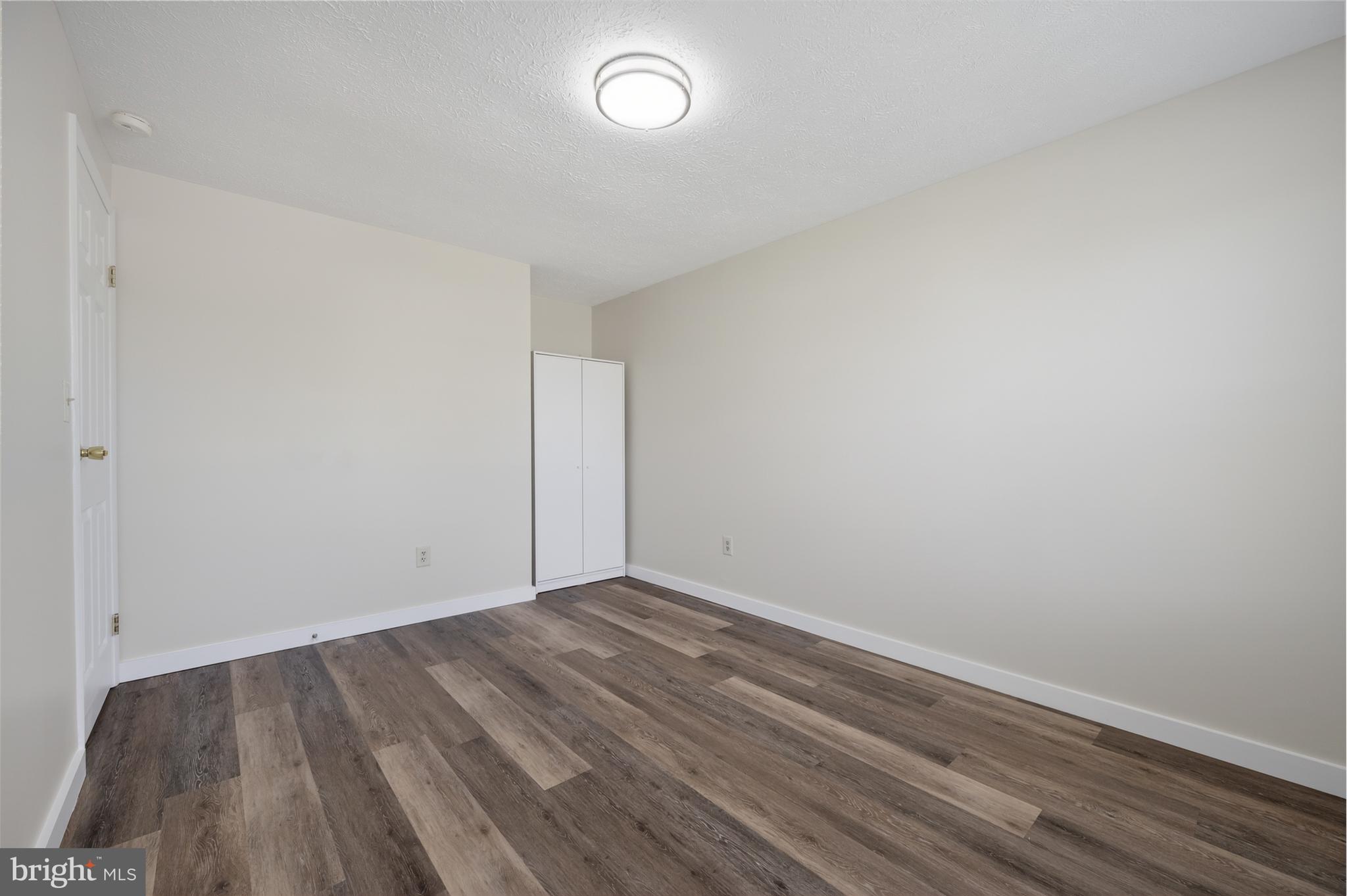 4429 Cub Run Road Chantilly, VA 20151 - Photo 21 of 56 an empty room with wooden floor and windows