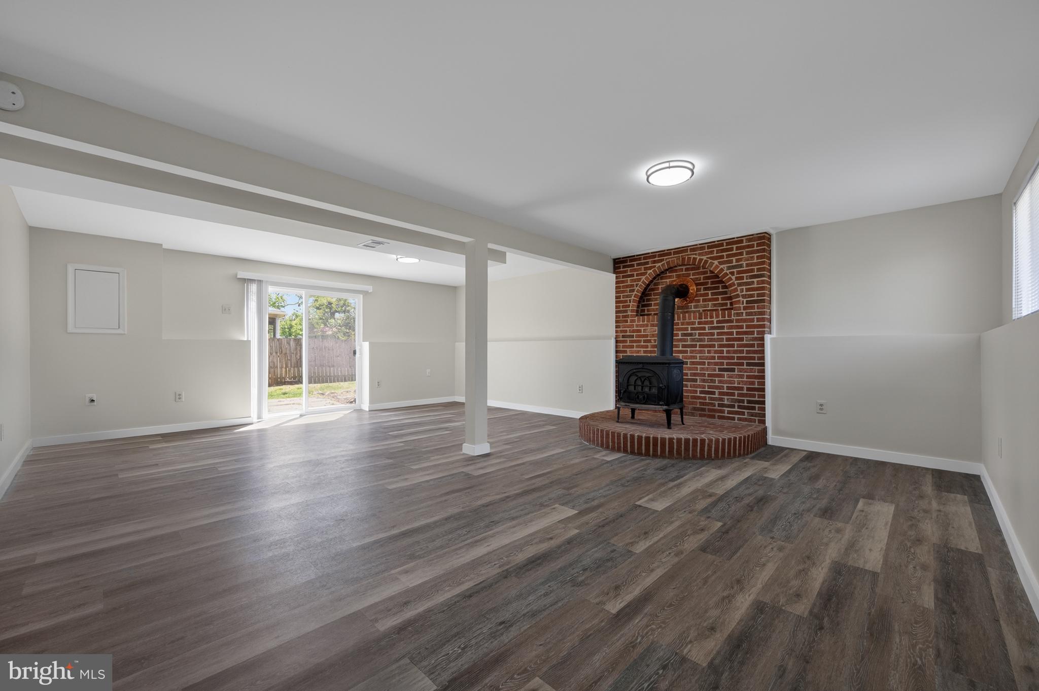 4429 Cub Run Road Chantilly, VA 20151 - Photo 26 of 56 a view of empty room with wooden floor and fireplace