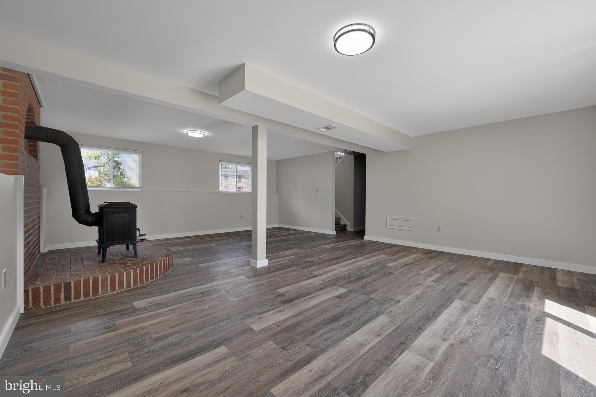 4429 Cub Run Road Chantilly, VA 20151 - Photo 30 of 56 an empty room with wooden floor and glass door