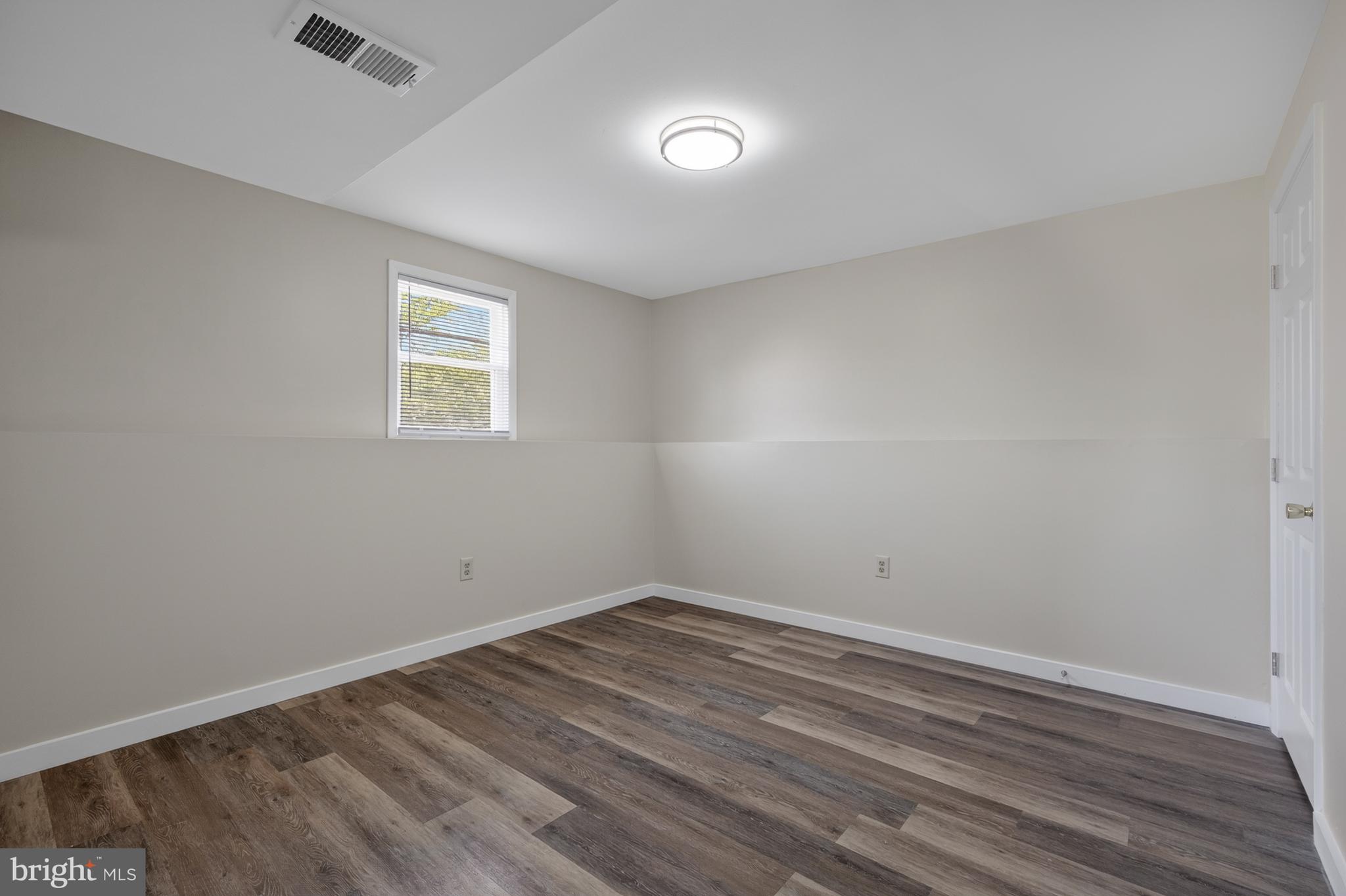4429 Cub Run Road Chantilly, VA 20151 - Photo 34 of 56 an empty room with wooden floor and windows