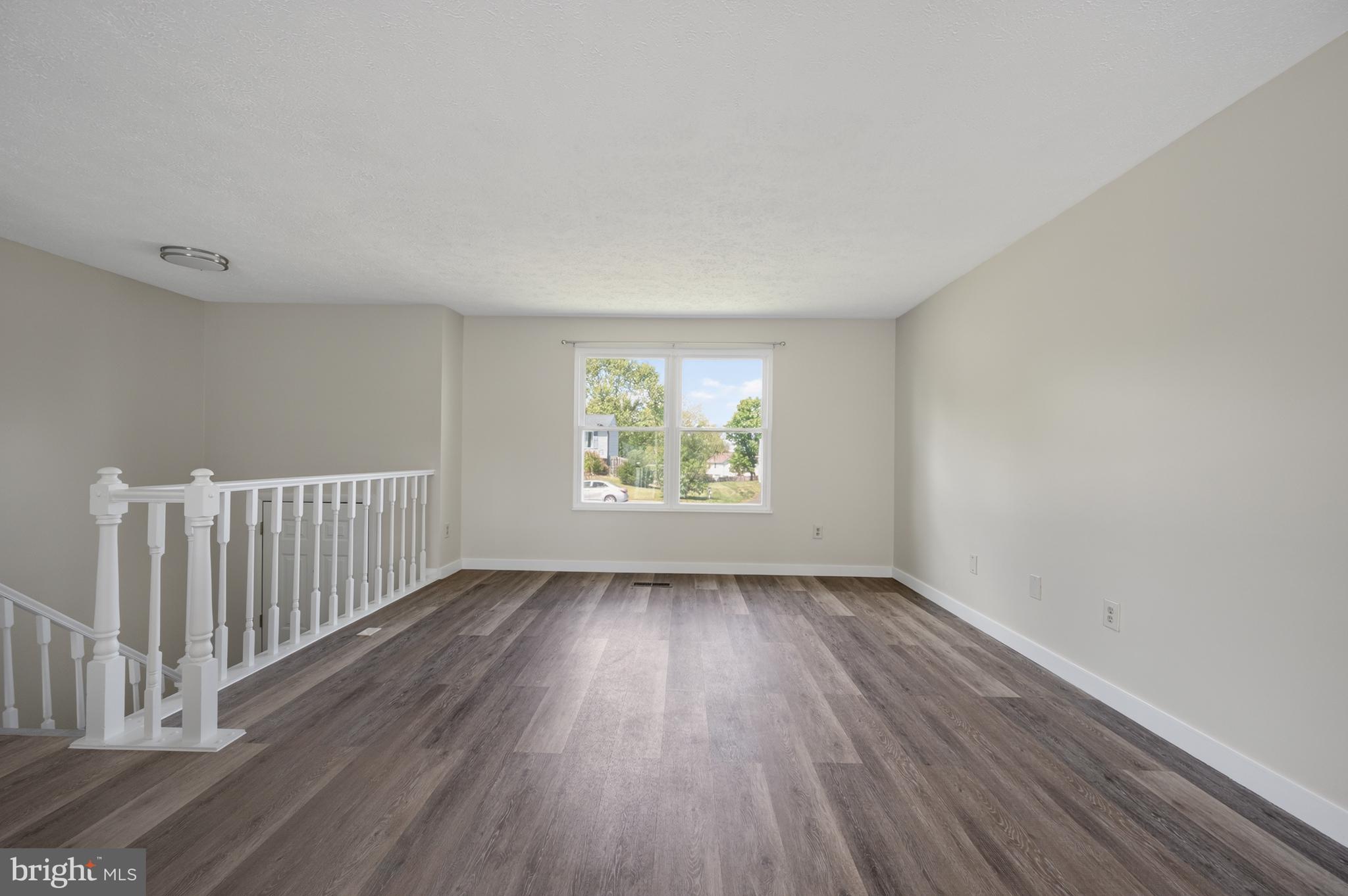 4429 Cub Run Road Chantilly, VA 20151 - Photo 6 of 56 an empty room with wooden floor and windows