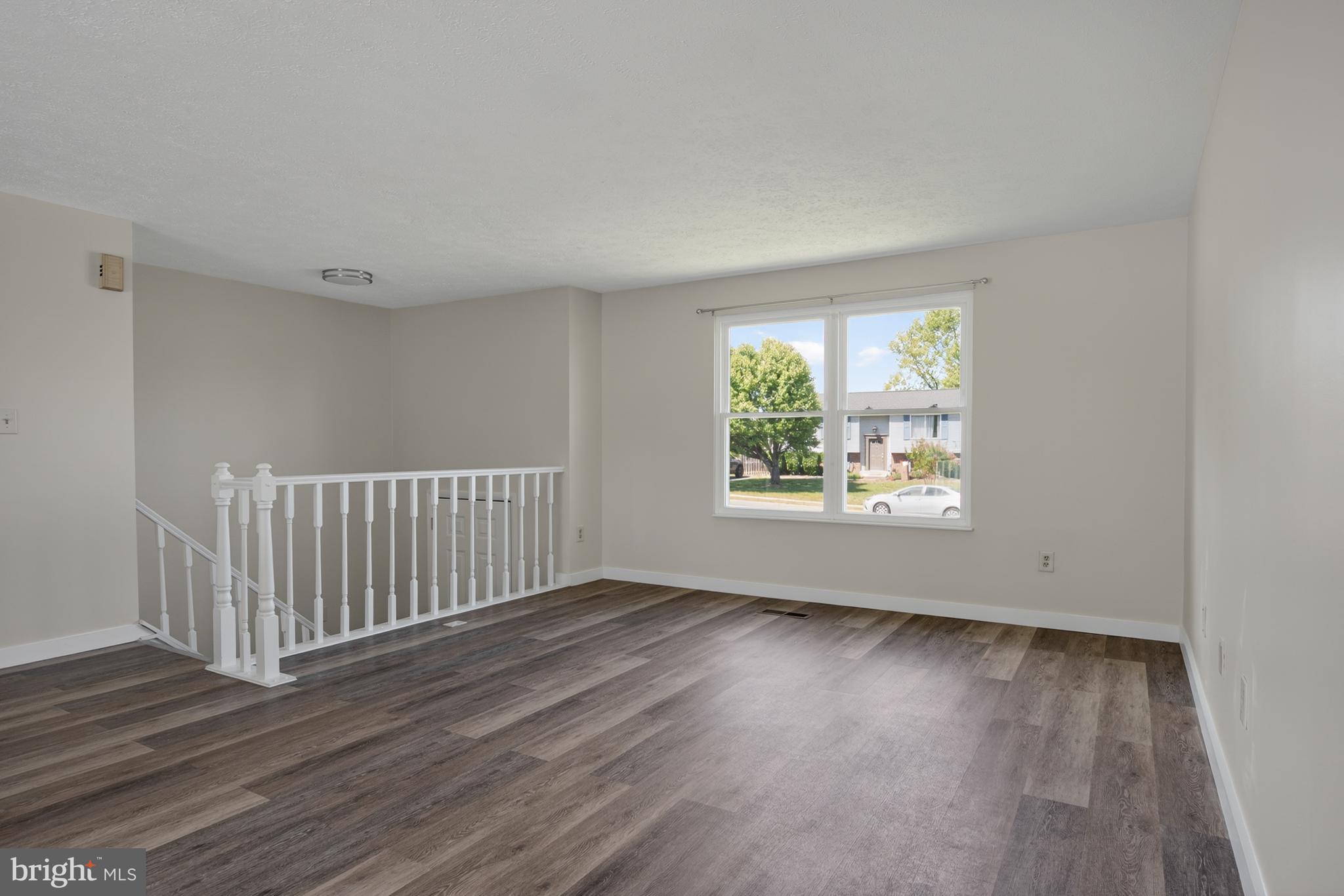 4429 Cub Run Road Chantilly, VA 20151 - Photo 7 of 56 a view of an empty room with wooden floor and a window