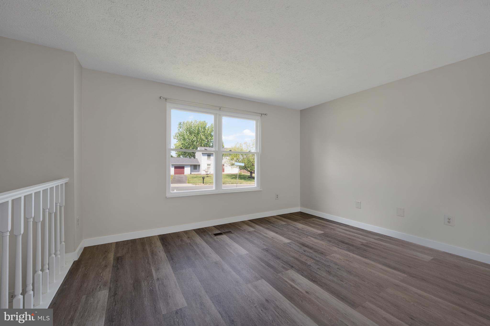 4429 Cub Run Road Chantilly, VA 20151 - Photo 8 of 56 an empty room with wooden floor and windows
