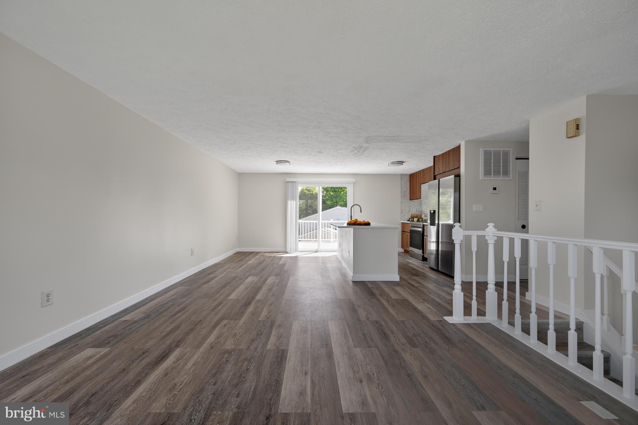 4429 Cub Run Road Chantilly, VA 20151 - Photo 10 of 56 a view of a living room hardwood floor and a kitchen
