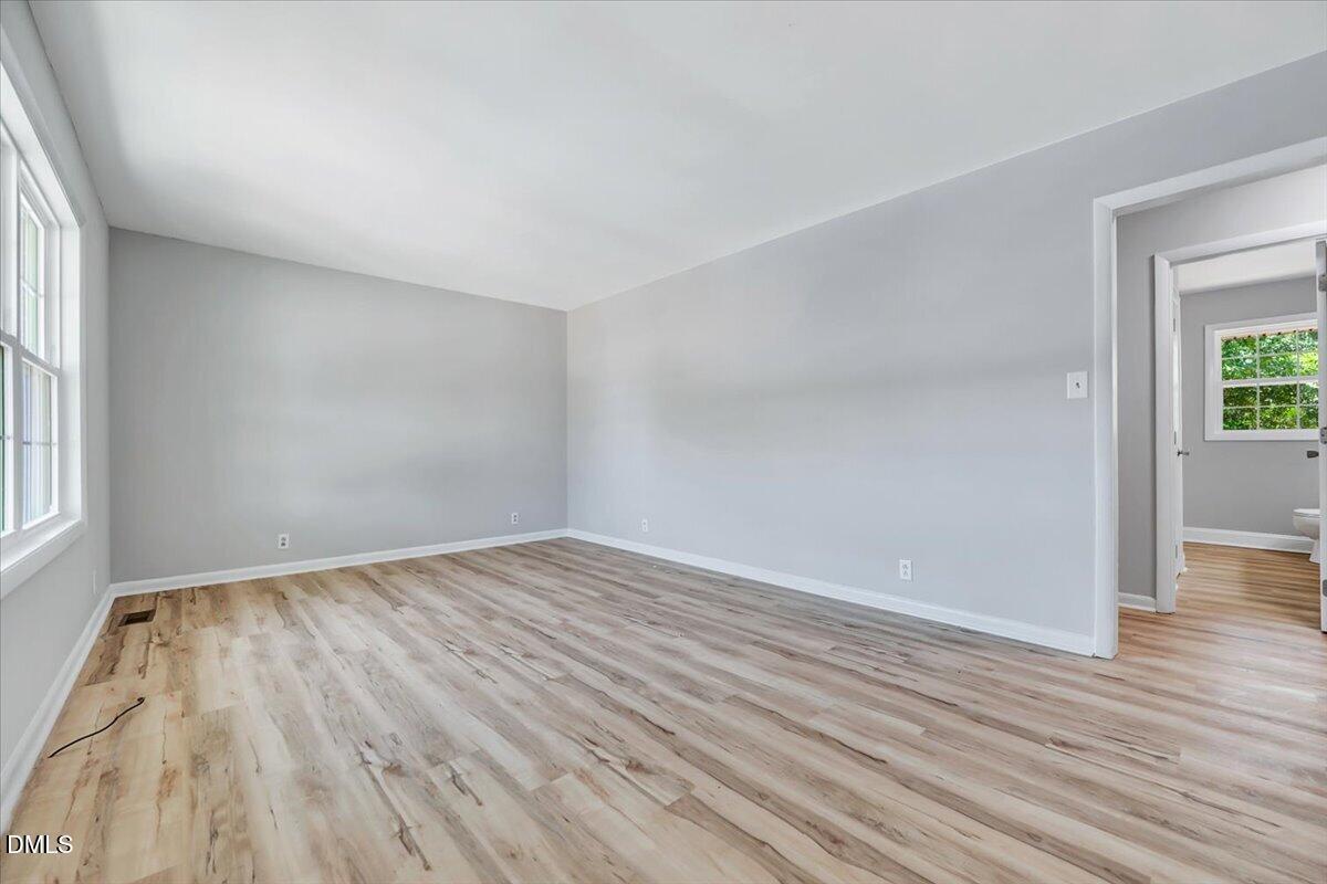 3408 Atlantic Avenue Raleigh, NC 27604 - Photo 5 of 48 wooden floor in an empty room with a window