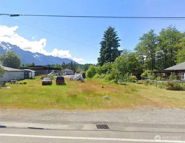a swimming pool with yard and mountain view in the background