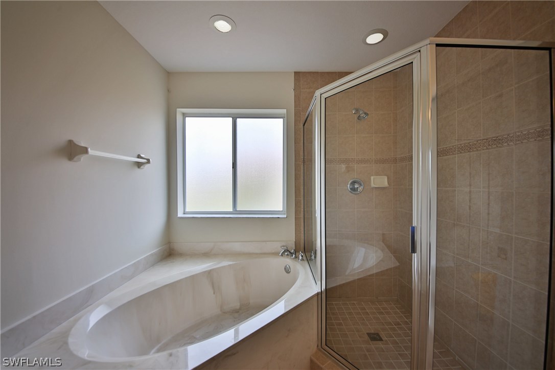 17521 Cherry Ridge Lane Fort Myers, FL 33967 - Photo 13 of 23 a bathroom with a tub and shower