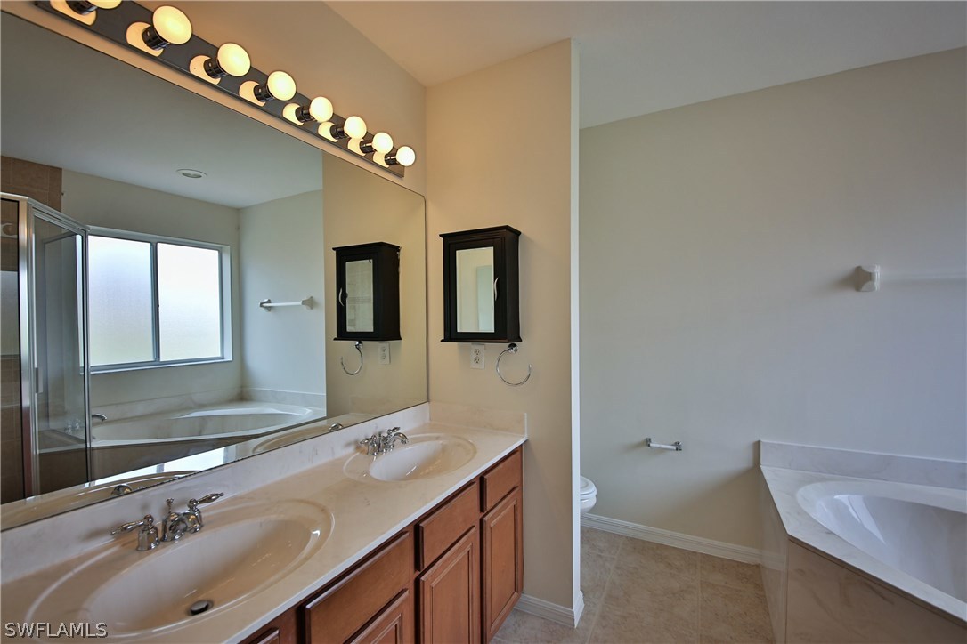 17521 Cherry Ridge Lane Fort Myers, FL 33967 - Photo 15 of 23 a bathroom with a double vanity sink and a mirror