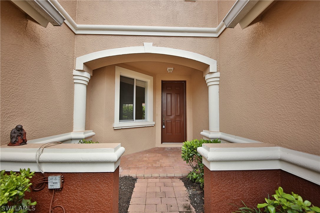 17521 Cherry Ridge Lane Fort Myers, FL 33967 - Photo 2 of 23 a front view of a house with a potted plant