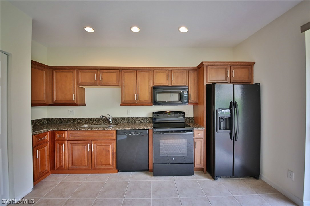 17521 Cherry Ridge Lane Fort Myers, FL 33967 - Photo 7 of 23 a kitchen with stainless steel appliances granite countertop a refrigerator and a sink