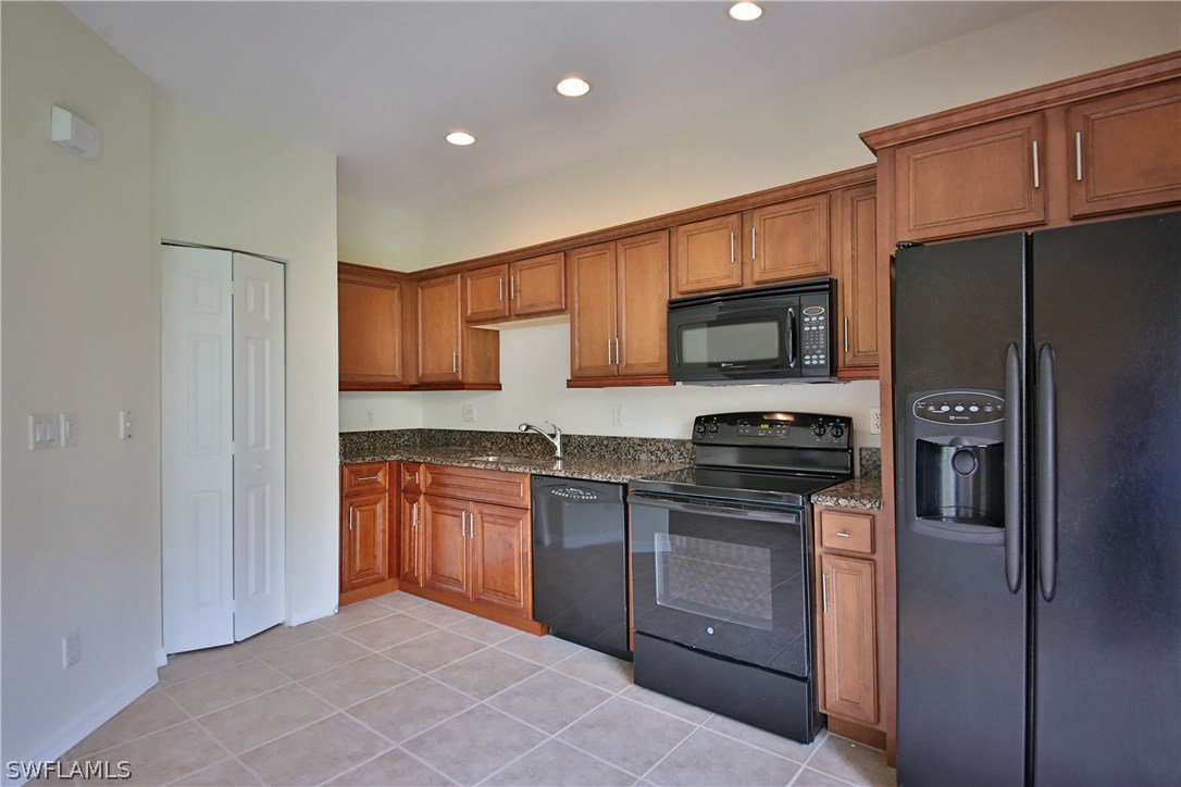 17521 Cherry Ridge Lane Fort Myers, FL 33967 - Photo 8 of 23 a kitchen with stainless steel appliances granite countertop a refrigerator stove and sink