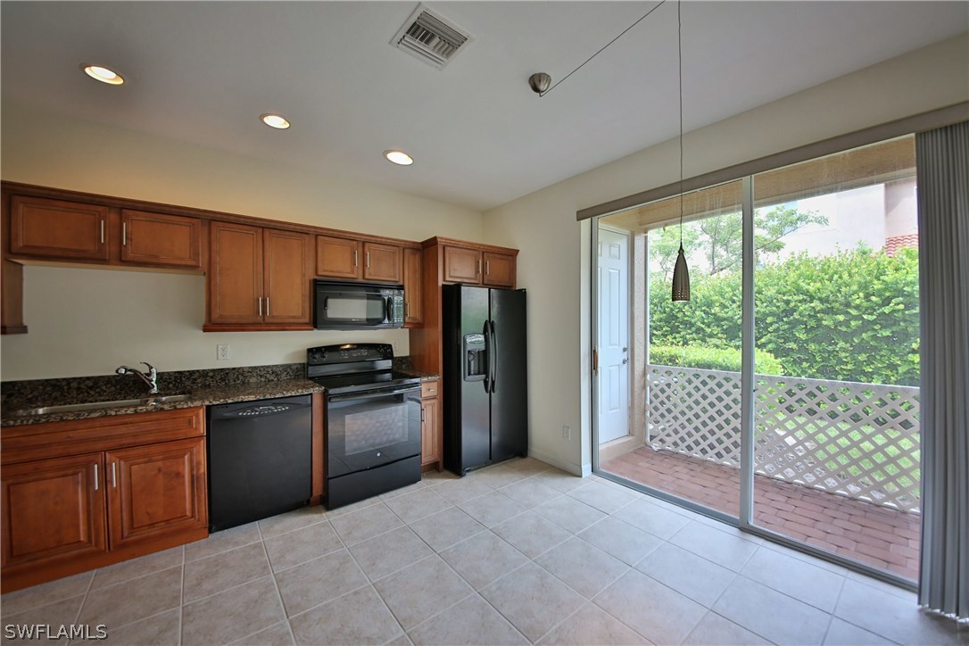 17521 Cherry Ridge Lane Fort Myers, FL 33967 - Photo 9 of 23 a kitchen with stainless steel appliances granite countertop a refrigerator and sink