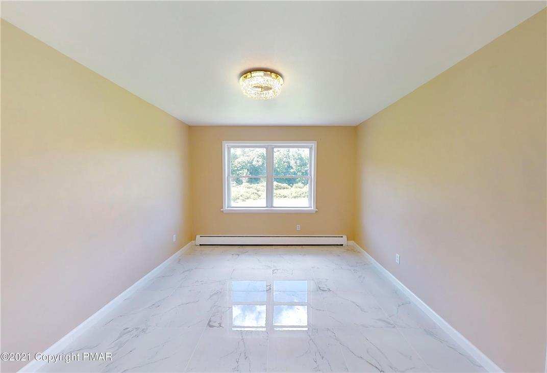 1110 Misty Ridge East Stroudsburg, PA 18302 - Photo 23 of 43 Marble-look flooring and a luminous ceiling fixture define this versatile room.