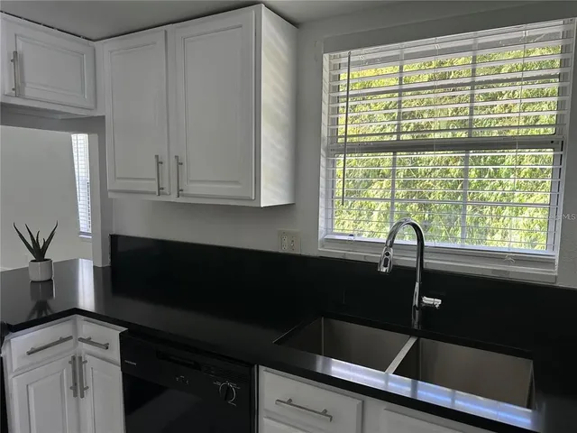 a kitchen with a sink and large window