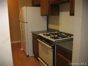 a bathroom with a granite countertop toilet and a sink