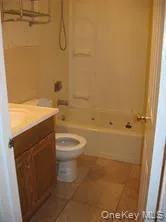 a view of a small space with wooden floor and a window