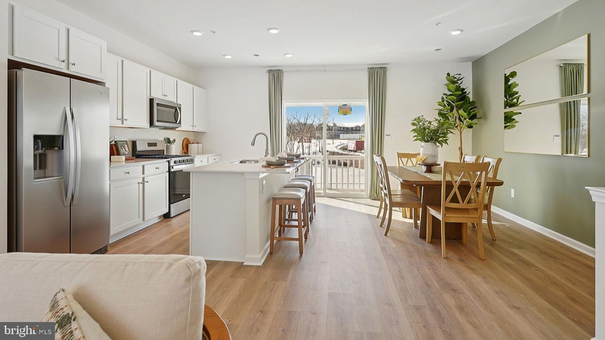 586 Swamp Creek Road Boyertown, PA 19512 - Photo 15 of 26 a living room with stainless steel appliances a dining table wooden floor and a view of kitchen