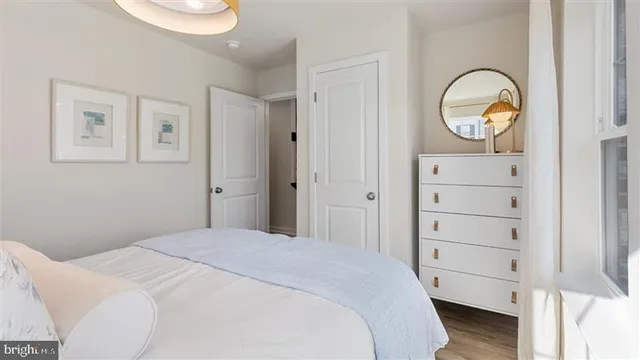 a bedroom with a bed and a painting on the wall