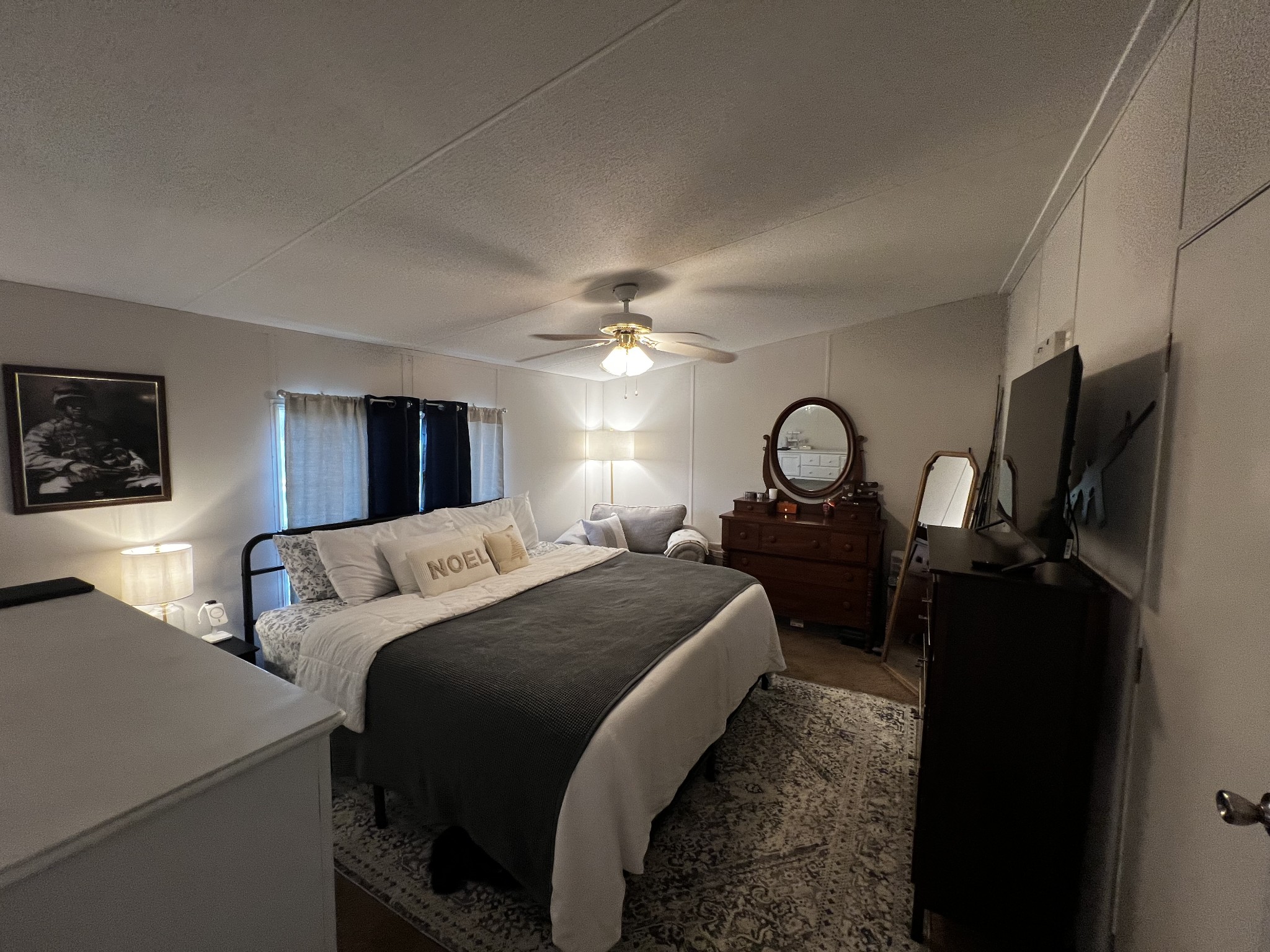 1870 Parker Road Manchester, TN 37355 - Photo 14 of 40 a bedroom with a bed a mirror on desk and a flat tv screen