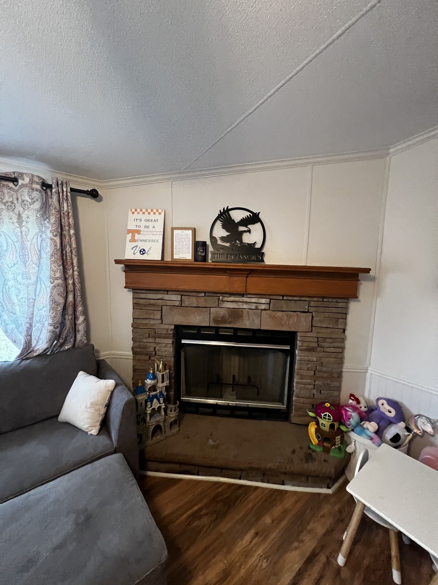 1870 Parker Road Manchester, TN 37355 - Photo 23 of 40 a living room with furniture a fireplace and a flat screen tv